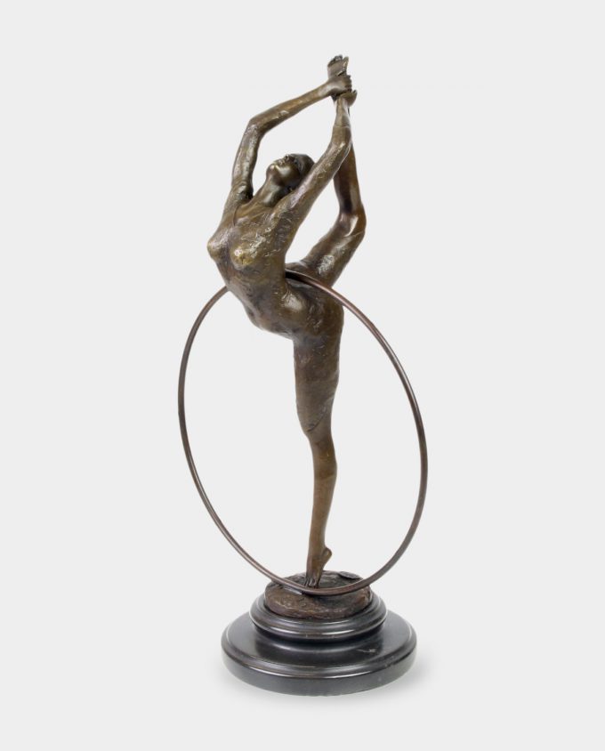 Dynamic bronze sculpture shows gymnast with hoop in vertical twine.